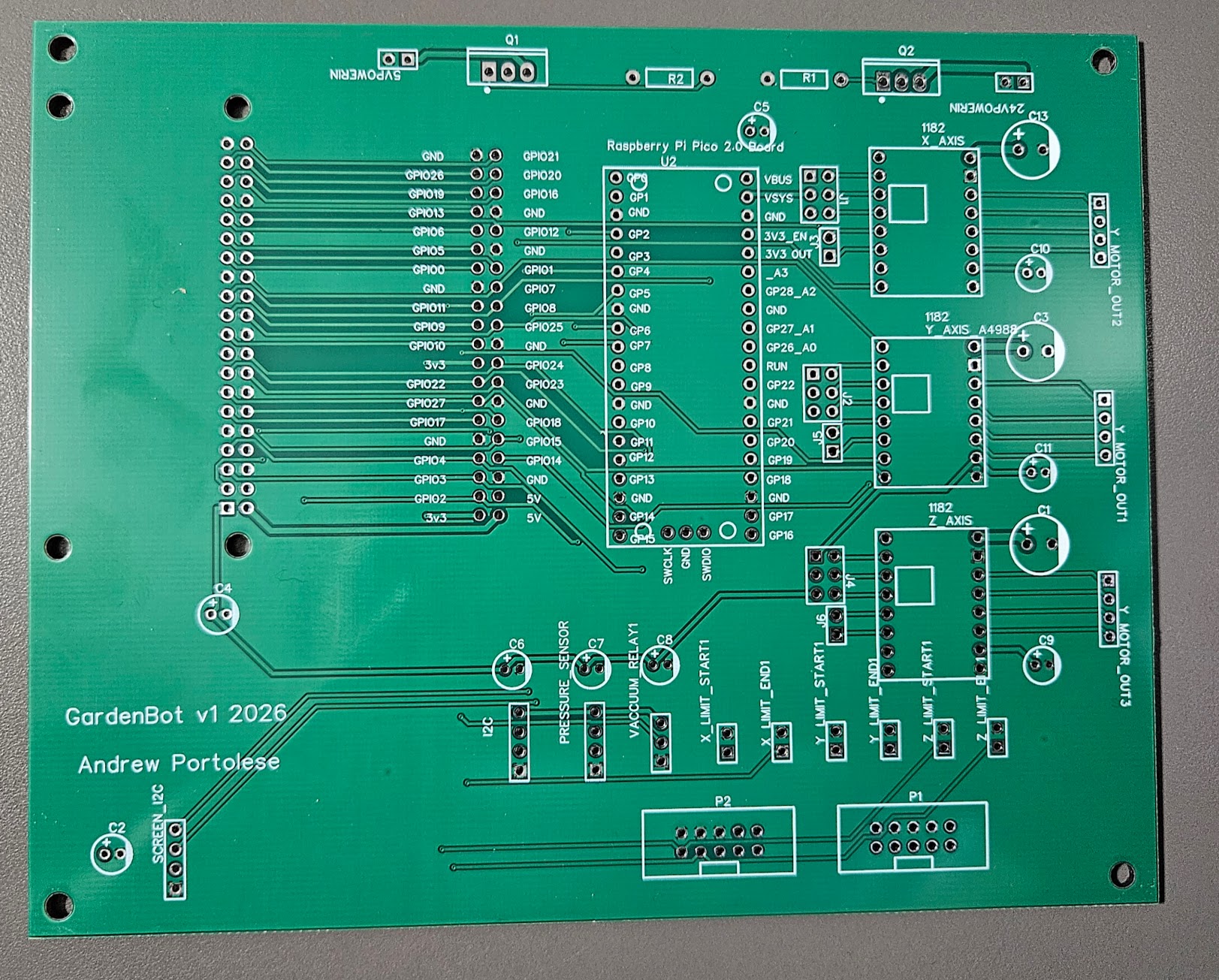 GardenBot v1 bare PCB fresh from fabrication, green solder mask with white silkscreen showing all component footprints and trace routing