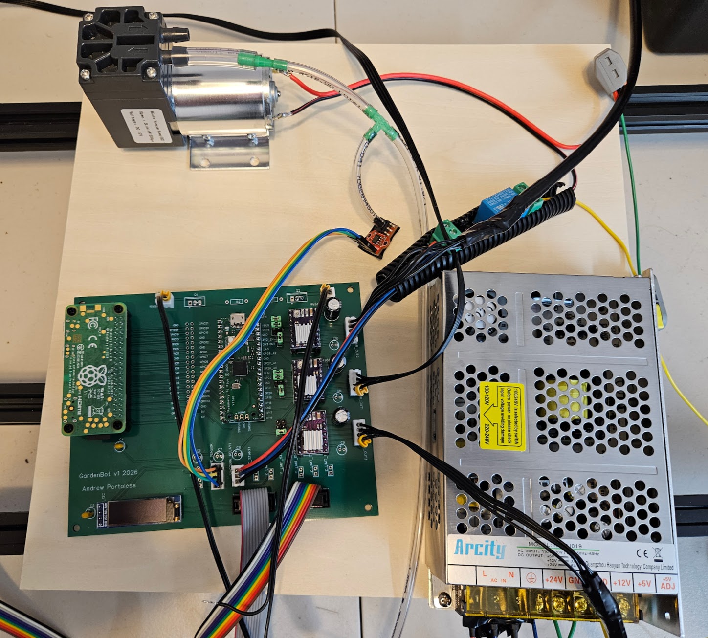 GardenBot v1 PCB installed in the robot frame, wired to the 24V power supply, vacuum pump, and stepper motors